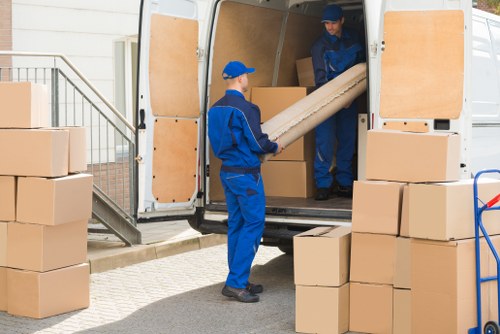 Man with van service loading furniture in Tooting Bec street