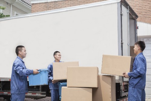 Local moving team handling furniture and boxes in South West London