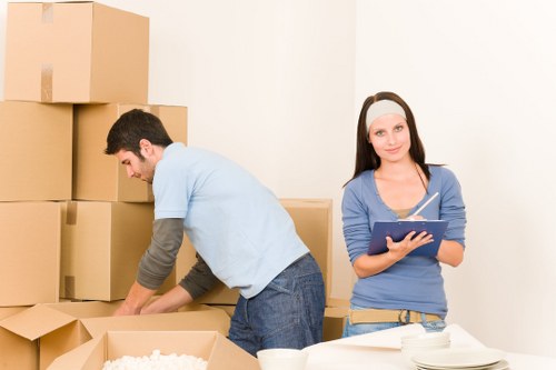 Household moving team handling boxes and furniture in Tooting Bec